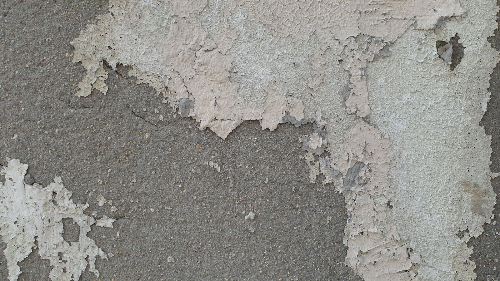 Epoxy garage floor peeling away from the slab and exposing bare concrete underneath
