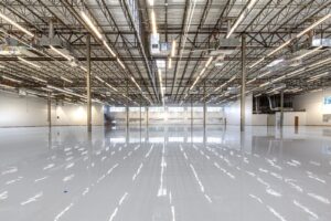 High gloss gray epoxy floor coating across a large open commercial space