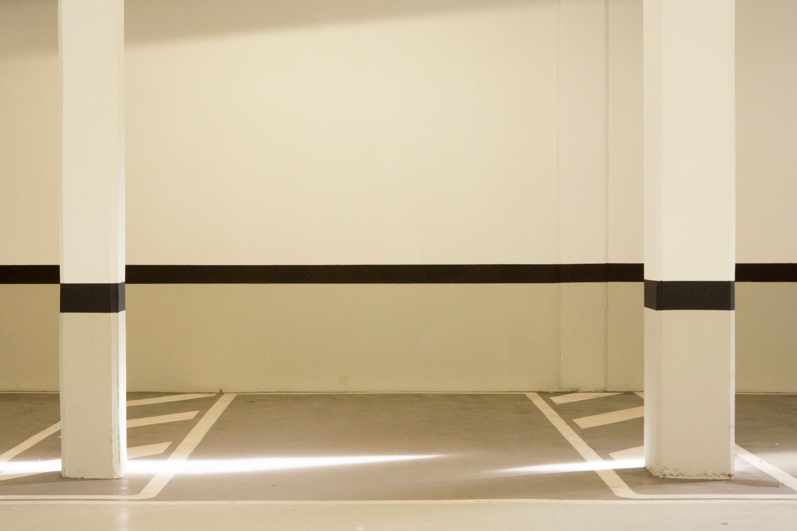 Coated concrete parking bay showing the smooth finish polyaspartic vs epoxy systems both produce