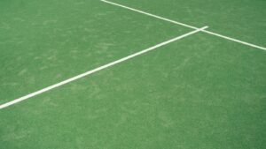 Green tennis court surface with fresh white line markings